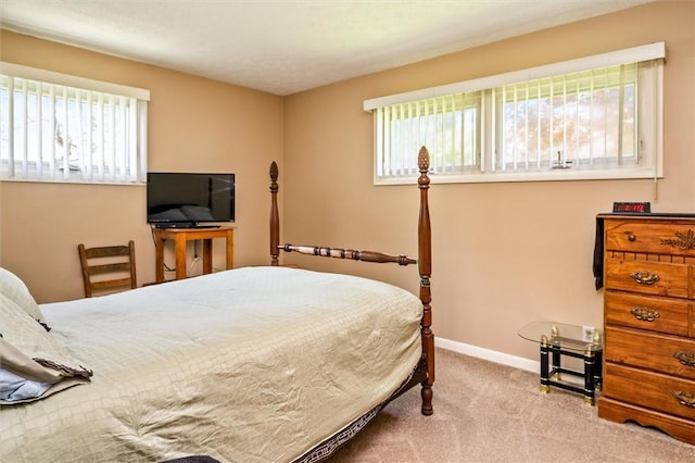 carpeted bedroom featuring baseboards