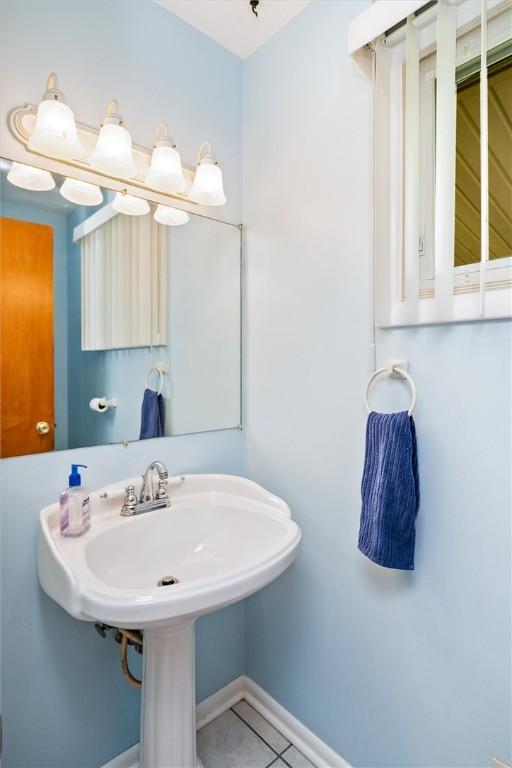 bathroom with tile patterned flooring and baseboards