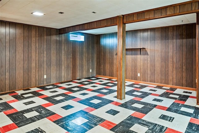 finished below grade area with wooden walls and tile patterned floors