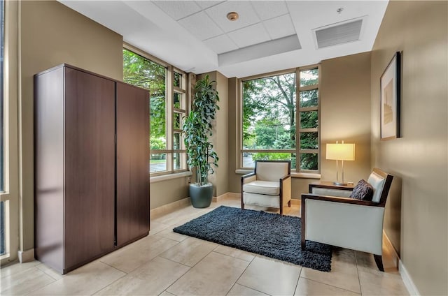 132 Lakefront Blvd Unit 104, Buffalo, NY 14202 - sitting room with plenty of natural light, baseboards, and light tile patterned flooring