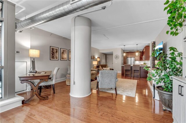 132 Lakefront Blvd Unit 104, Buffalo, NY 14202 - living area featuring light wood-type flooring and decorative columns