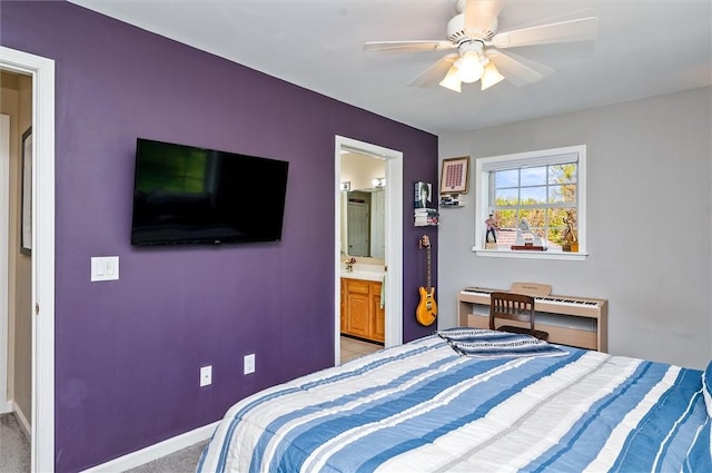 bedroom with ensuite bath, baseboards, ceiling fan, and light colored carpet
