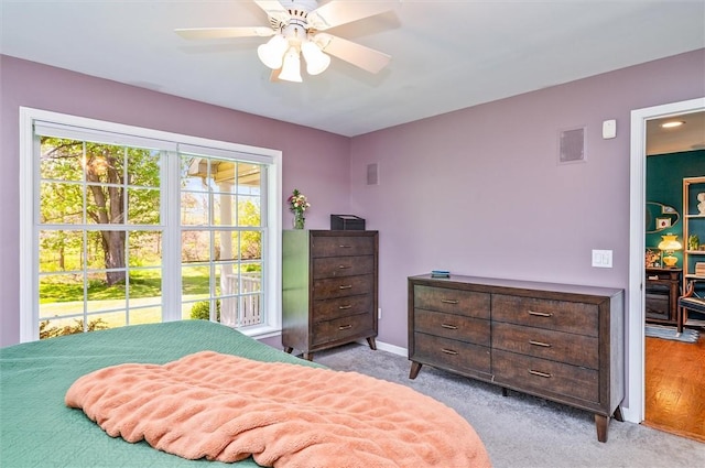 bedroom with light carpet, a ceiling fan, and baseboards