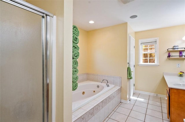full bath featuring tile patterned flooring, a shower stall, a tub with jets, vanity, and baseboards