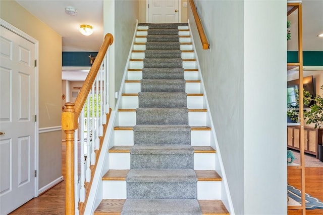 staircase featuring wood finished floors