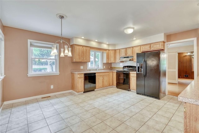 kitchen featuring black appliances, light brown cabinetry, under cabinet range hood, and light countertops