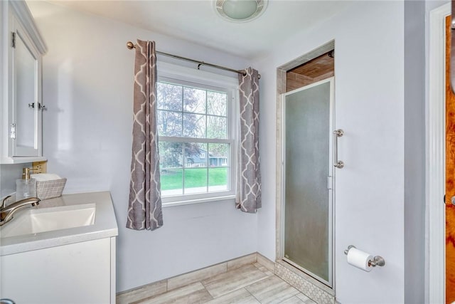 full bath with a shower stall and vanity