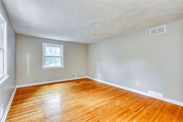 unfurnished room featuring light wood-type flooring and baseboards