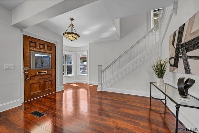 656 Auburn Ave, Buffalo, NY 14222 - foyer with stairs, baseboards, wood finished floors, and a chandelier