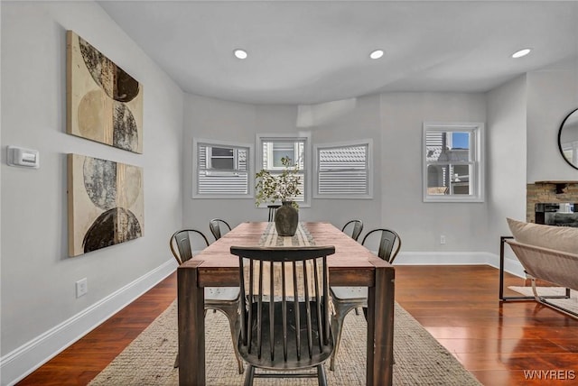 656 Auburn Ave, Buffalo, NY 14222 - dining space featuring baseboards, dark wood-style floors, recessed lighting, and a fireplace