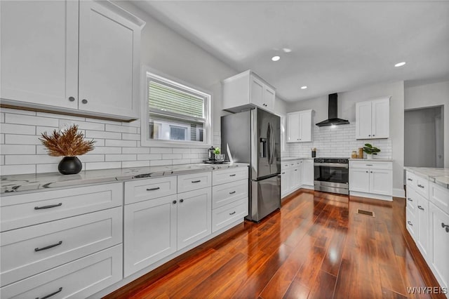 656 Auburn Ave, Buffalo, NY 14222 - kitchen featuring stainless steel appliances, wall chimney range hood, tasteful backsplash, light stone counters, and white cabinets
