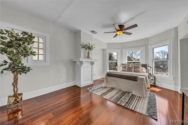 656 Auburn Ave, Buffalo, NY 14222 - bedroom with multiple windows, wood finished floors, baseboards, and ceiling fan