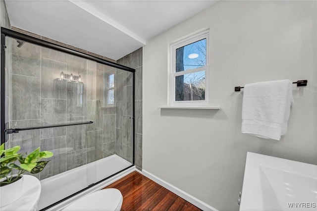 656 Auburn Ave, Buffalo, NY 14222 - bathroom featuring toilet, baseboards, wood finished floors, and a shower with shower door