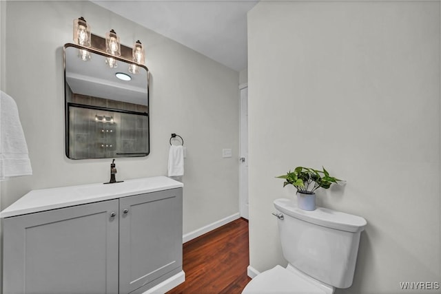 656 Auburn Ave, Buffalo, NY 14222 - bathroom featuring toilet, wood finished floors, baseboards, and vanity