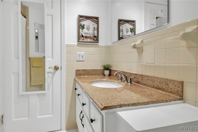 bathroom featuring tile walls and vanity