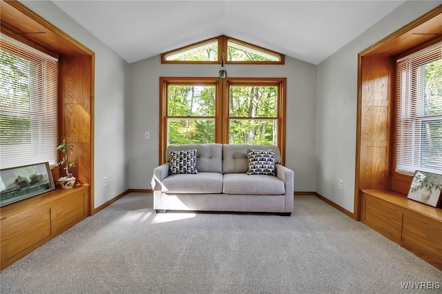 carpeted living room featuring vaulted ceiling and baseboards