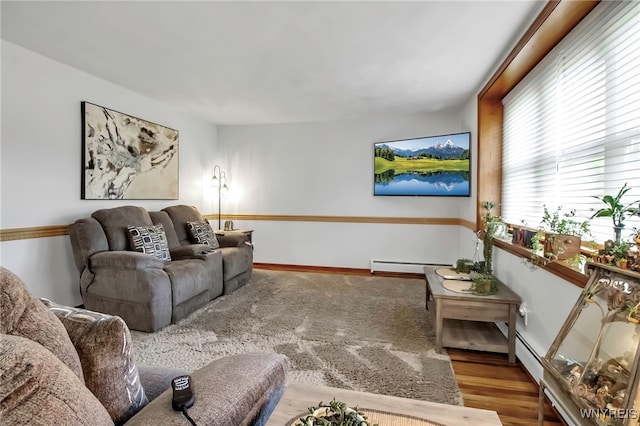 living area with a baseboard radiator and wood finished floors
