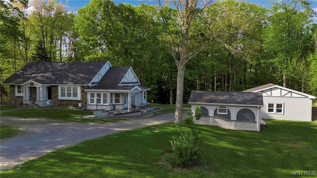 single story home with driveway, a front lawn, and stucco siding