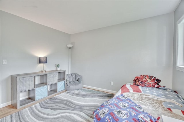 bedroom featuring baseboards and wood finished floors