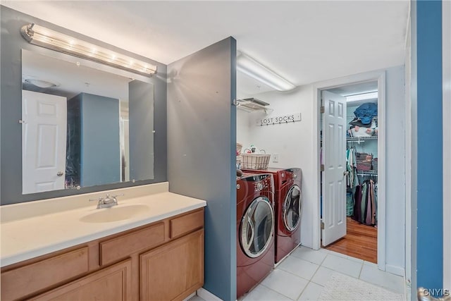bathroom with washer and dryer, tile patterned flooring, and vanity
