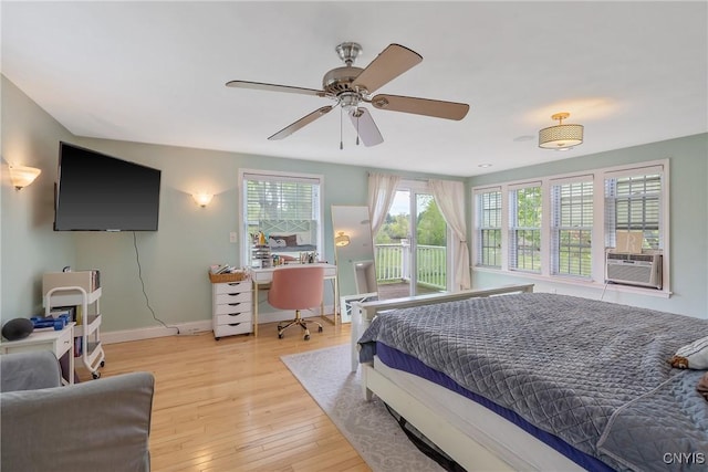 bedroom featuring an office area, wood finished floors, baseboards, access to exterior, and ceiling fan
