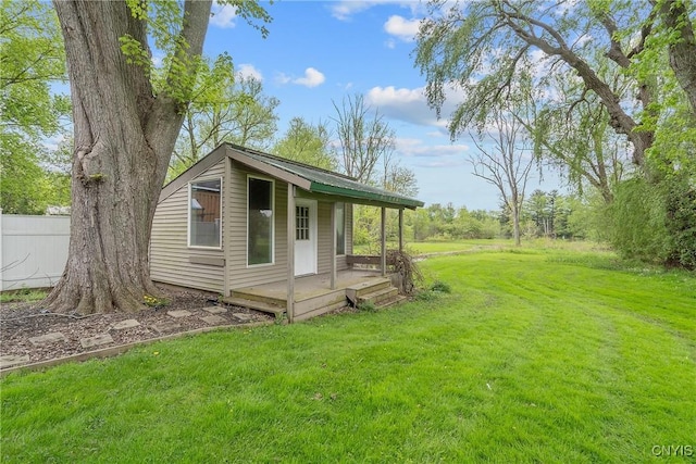 view of front of home with a front yard and an outdoor structure
