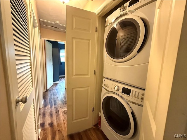 1004 W Thomas St, Rome-Inside, NY 13440 - washroom with estacked washer and dryer and dark wood-style flooring
