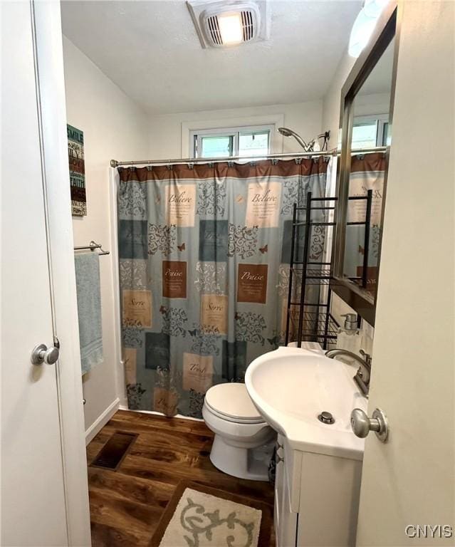 1004 W Thomas St, Rome-Inside, NY 13440 - full bathroom with wood finished floors, curtained shower, toilet, and vanity