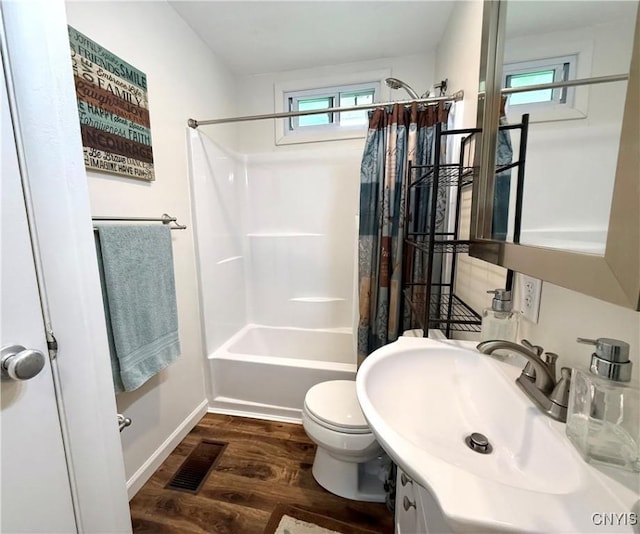 1004 W Thomas St, Rome-Inside, NY 13440 - bathroom with wood finished floors, shower / tub combo with curtain, toilet, vanity, and baseboards