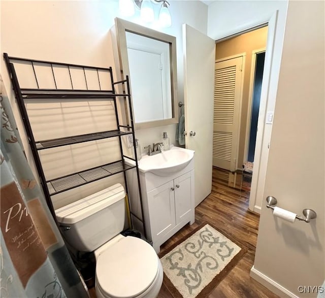 1004 W Thomas St, Rome-Inside, NY 13440 - bathroom featuring wood finished floors, toilet, vanity, and baseboards