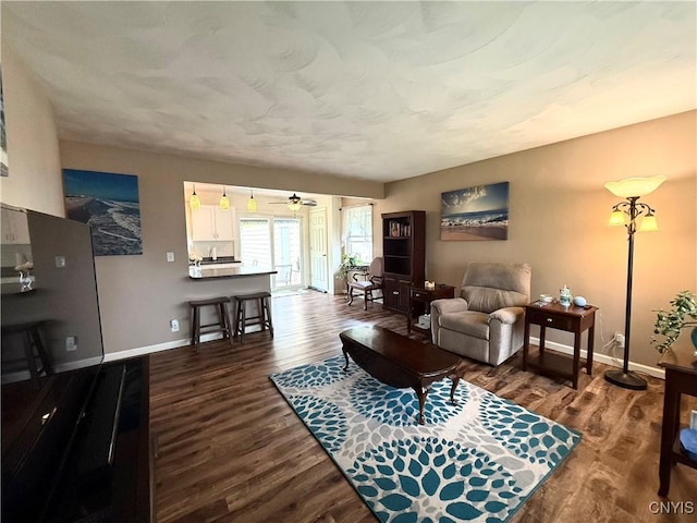 1004 W Thomas St, Rome-Inside, NY 13440 - living area with baseboards, dark wood finished floors, and ceiling fan