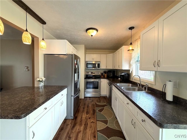 1004 W Thomas St, Rome-Inside, NY 13440 - kitchen featuring appliances with stainless steel finishes, a sink, dark countertops, and dark wood finished floors