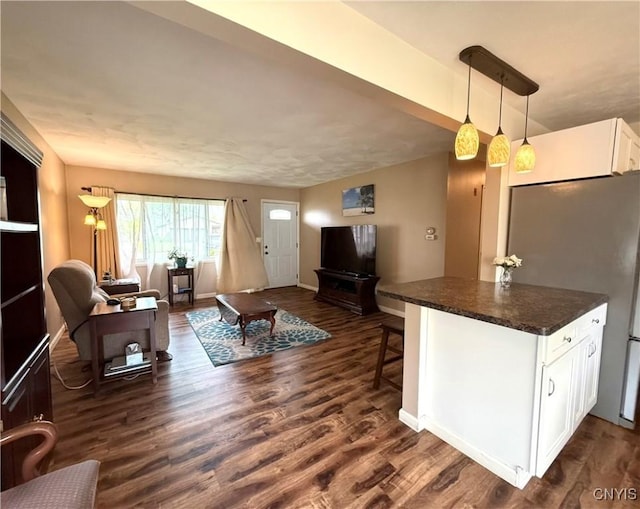 1004 W Thomas St, Rome-Inside, NY 13440 - living area with dark wood-type flooring and baseboards
