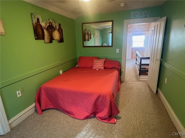 bedroom featuring carpet and baseboards