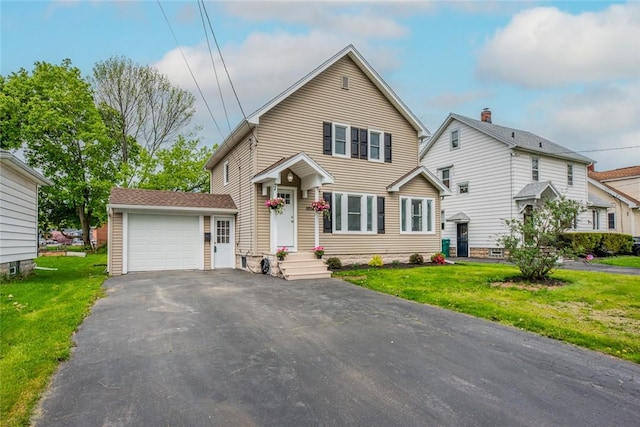 traditional home with asphalt driveway, a front yard, and a garage