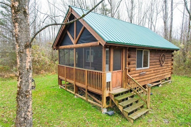 345 Orton Rd, Sandy Creek, NY 13142 - view of front of home featuring metal roof, a sunroom, a front lawn, and log exterior