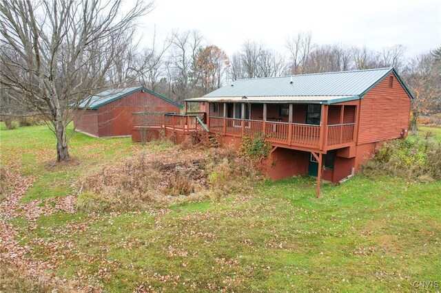 345 Orton Rd, Sandy Creek, NY 13142 - rear view of house with a lawn, a wooden deck, and metal roof