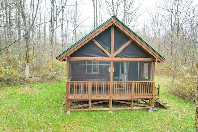 345 Orton Rd, Sandy Creek, NY 13142 - rear view of property with a sunroom, a wooded view, and a lawn