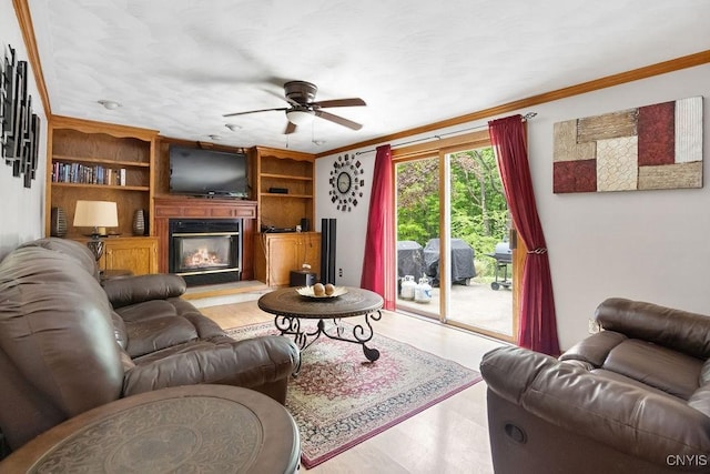 108 Pineledge Rd, Camillus, NY 13031 - living room with ceiling fan, crown molding, light wood-style floors, and a glass covered fireplace