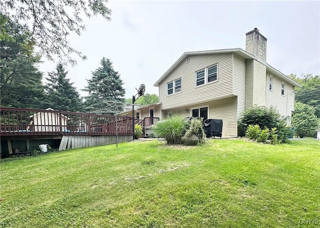 108 Pineledge Rd, Camillus, NY 13031 - rear view of house with a deck, a chimney, and a lawn