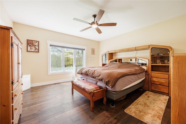 bedroom featuring wood finished floors, baseboards, and a ceiling fan