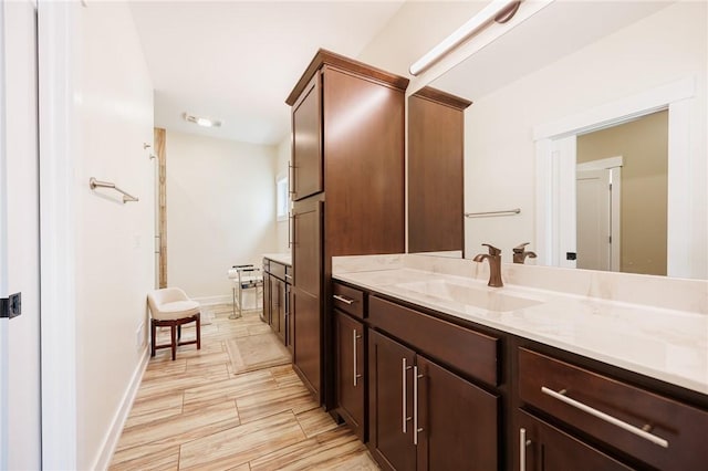 full bathroom with vanity and baseboards