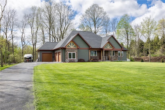 craftsman-style house with an attached garage, stone siding, asphalt driveway, and a front lawn