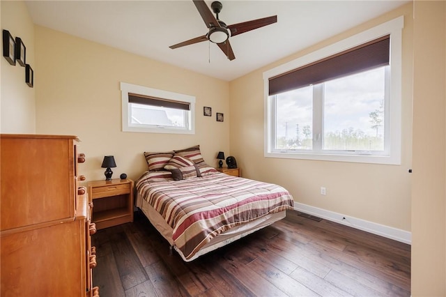 bedroom with baseboards, dark wood-style floors, and ceiling fan