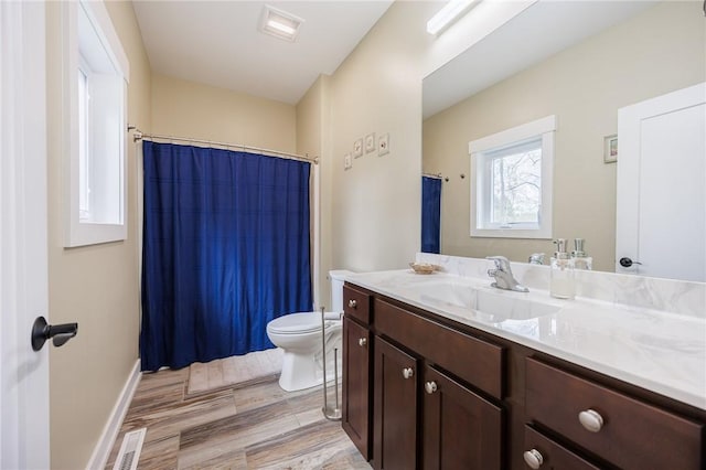 full bath with toilet, vanity, wood finished floors, and curtained shower