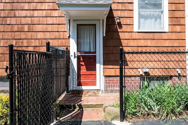 doorway to property featuring fence