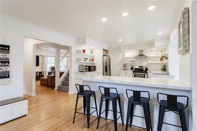 137 Vine St, Batavia-City, NY 14020 - kitchen with open shelves, stainless steel appliances, wall chimney exhaust hood, white cabinetry, and crown molding