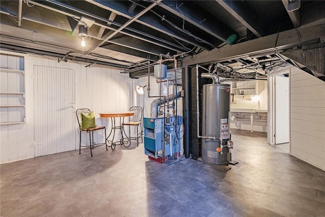 unfinished below grade area with water heater and a heating unit