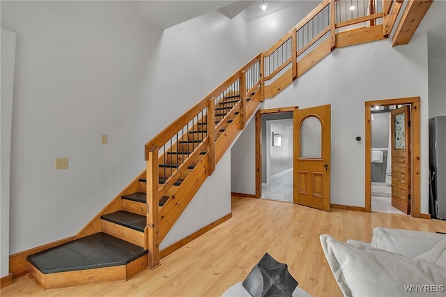 9466 Ridge Rd, Hartland, NY 14105 - stairs with wood finished floors, baseboards, and a high ceiling