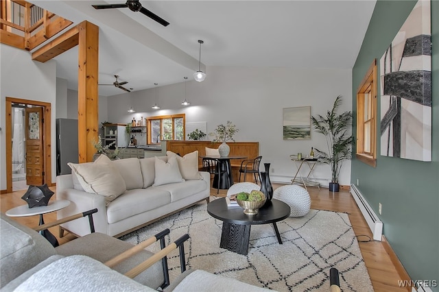 9466 Ridge Rd, Hartland, NY 14105 - living room featuring baseboard heating, ceiling fan, light wood-style flooring, lofted ceiling, and baseboards